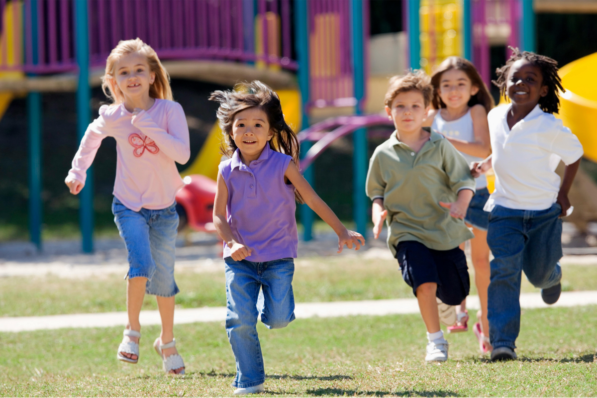 Kinder laufen über Rasen